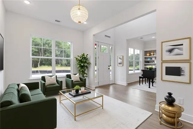 a living room with furniture a chandelier and a window