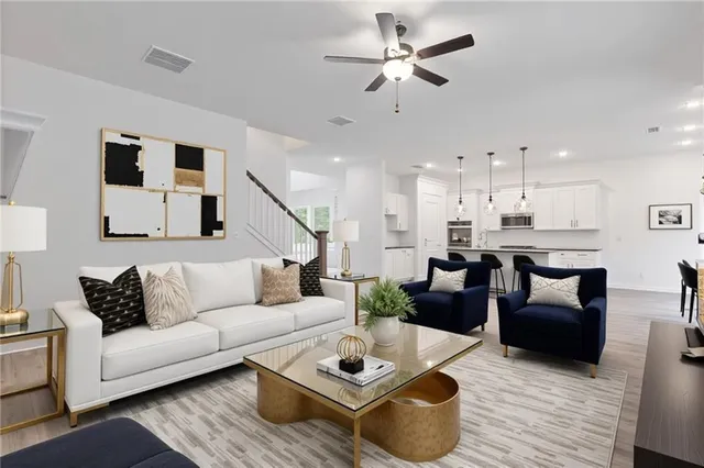 a living room with furniture and kitchen view