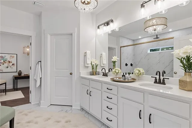 a spacious en suite bathroom with double sink and a mirror