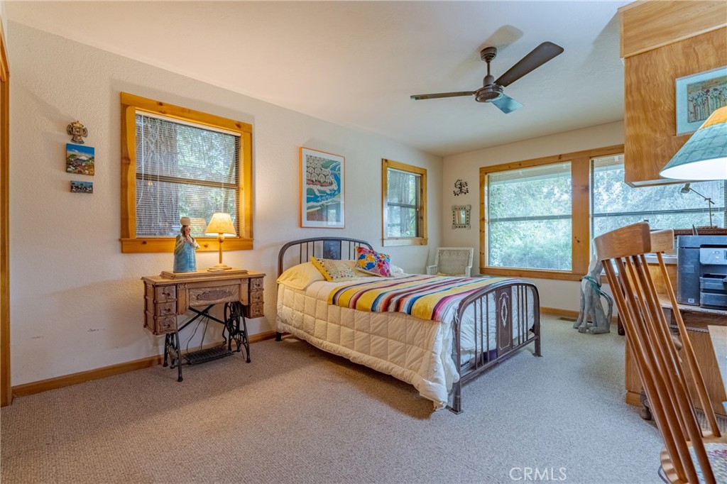 3279 Merced Falls Road Snelling, CA 95369 - Photo 46 of 73 a spacious bedroom with a bed a table and windows