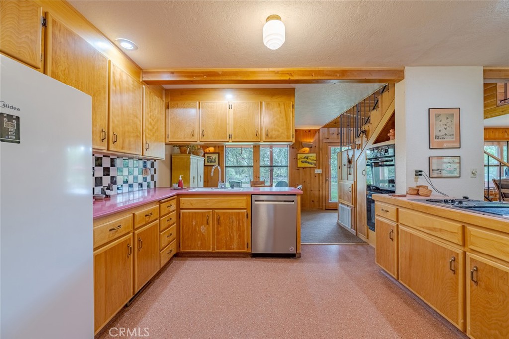3279 Merced Falls Road Snelling, CA 95369 - Photo 49 of 73 a large kitchen with stainless steel appliances granite countertop a large window and a sink