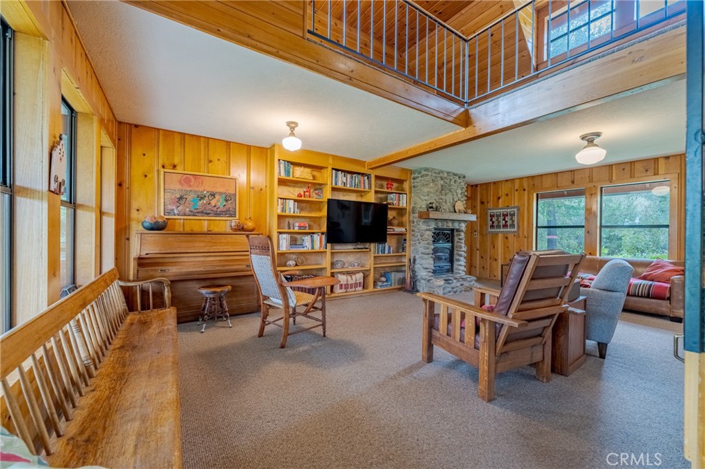 3279 Merced Falls Road Snelling, CA 95369 - Photo 58 of 73 a living room with furniture a flat screen tv and floor to ceiling window