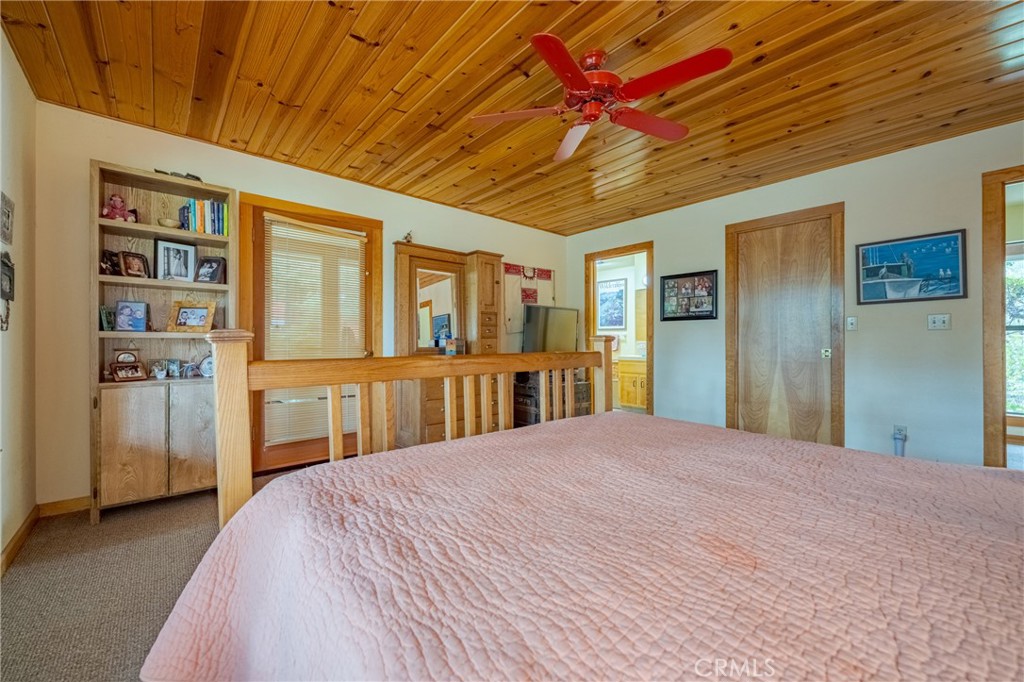 3279 Merced Falls Road Snelling, CA 95369 - Photo 62 of 73 a bedroom with a large bed and a chandelier