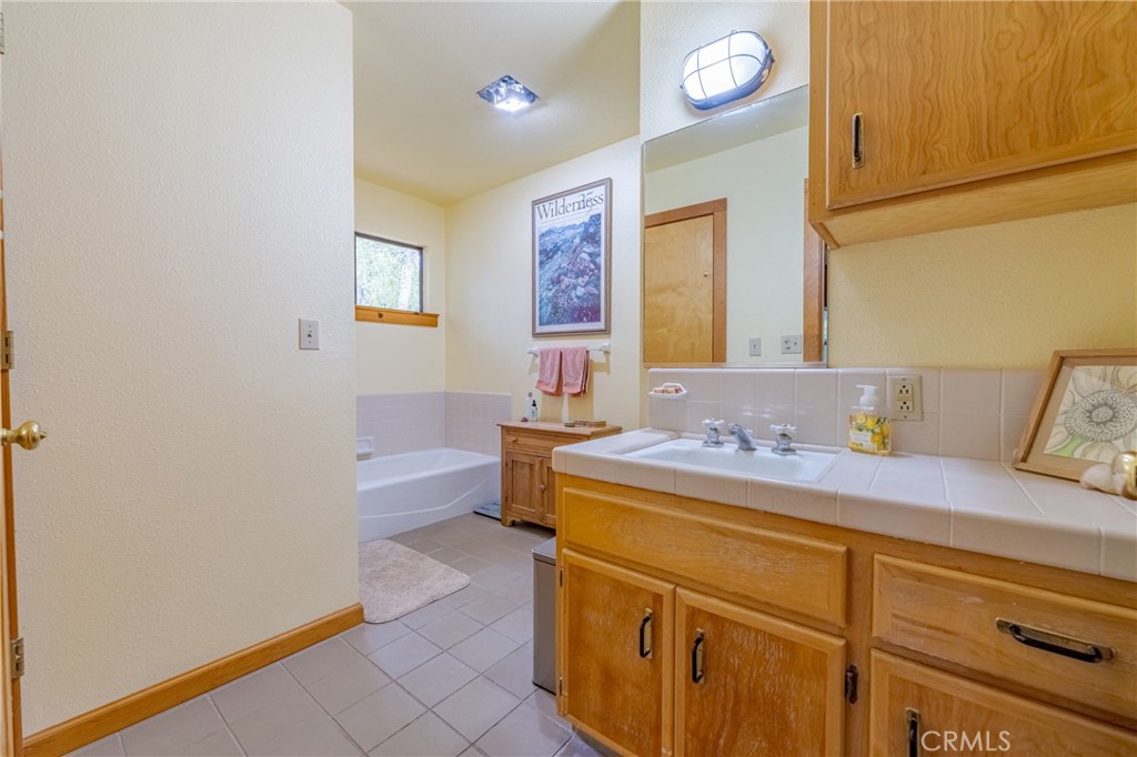 3279 Merced Falls Road Snelling, CA 95369 - Photo 63 of 73 a bathroom with a sink a vanity and a mirror
