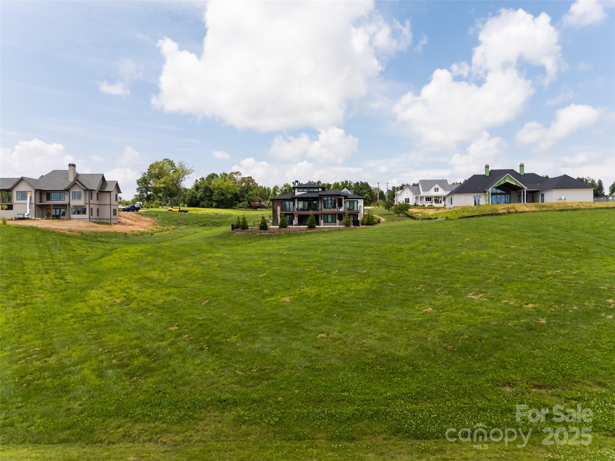 106 Double Knob Road, Unit LOT 64 Mills River, NC 28759 - Photo 7 of 19 a view of a field with houses in the background