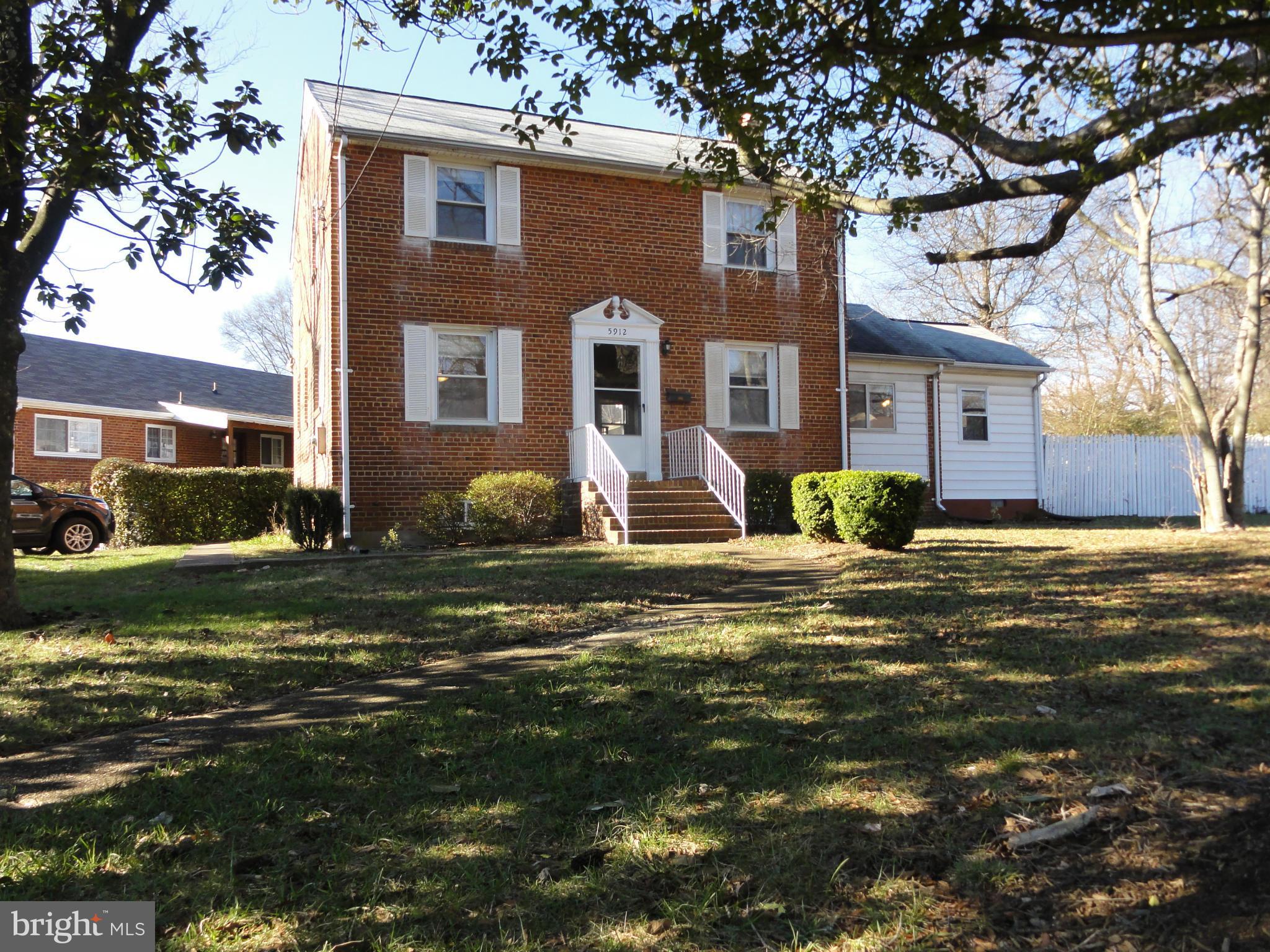 5912 Backlick Road Springfield, VA 22150 - Photo 1 of 28 a front view of a house with a yard