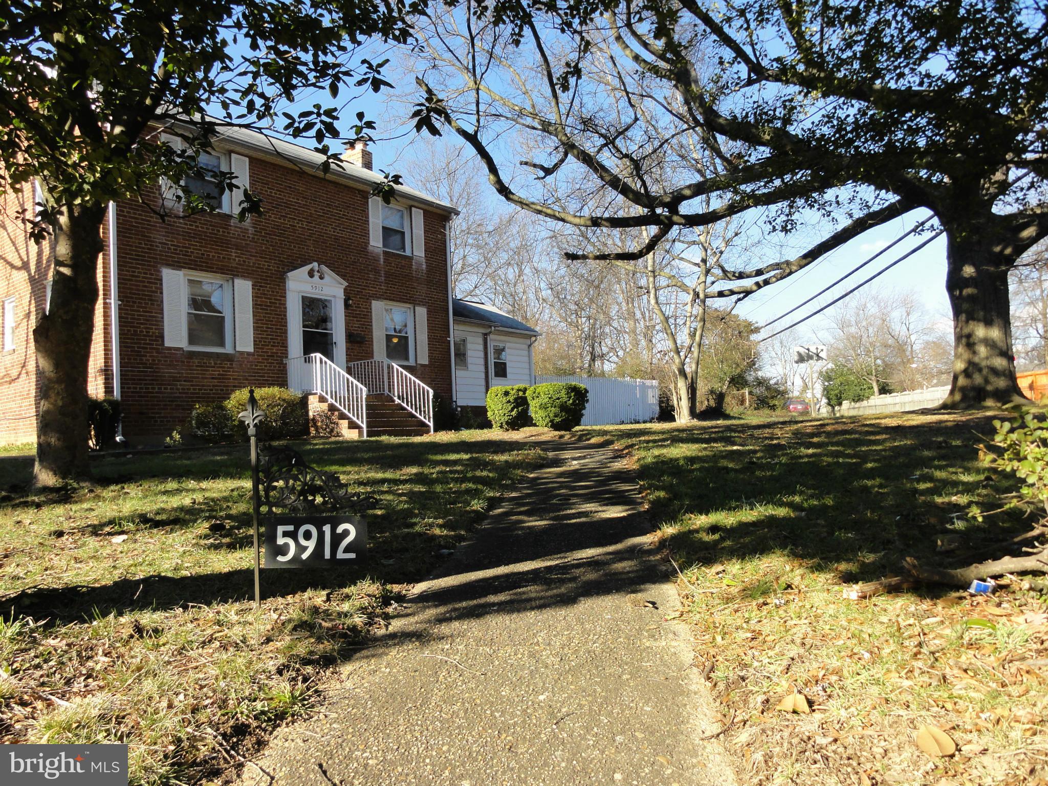 5912 Backlick Road Springfield, VA 22150 - Photo 2 of 28 a front view of a house with a yard covered with snow