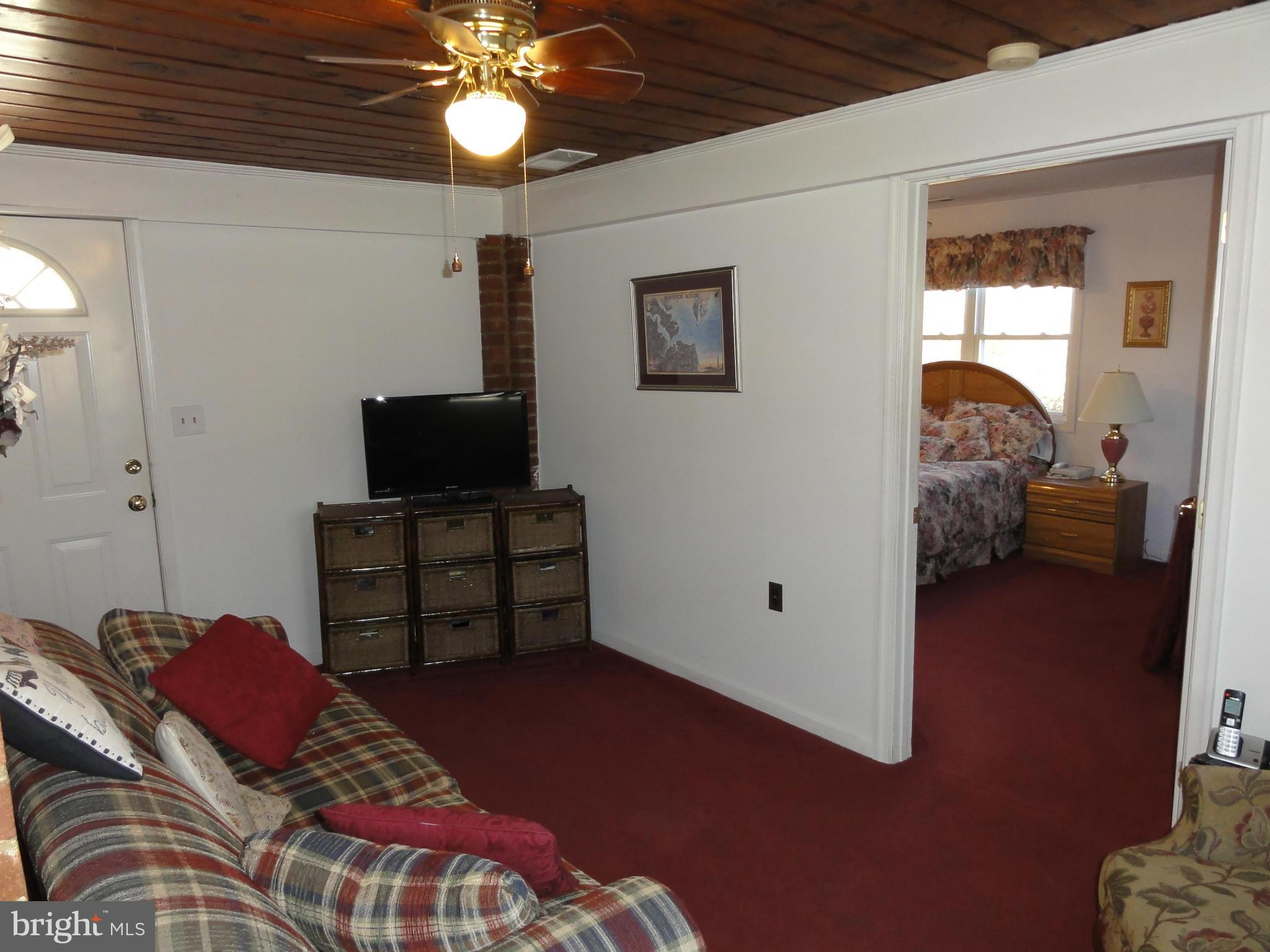 5912 Backlick Road Springfield, VA 22150 - Photo 15 of 28 a bedroom with bed and a chandelier