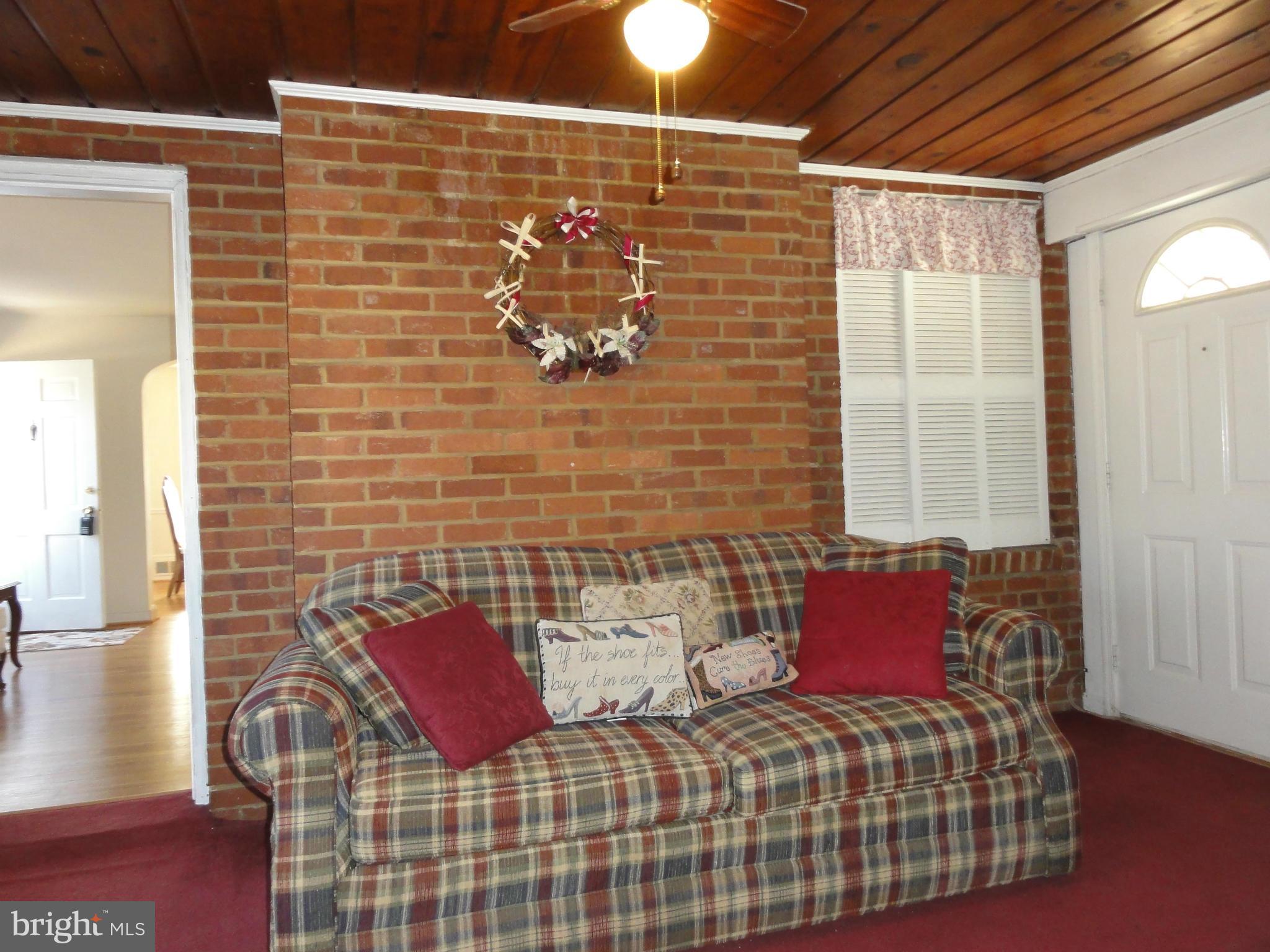 5912 Backlick Road Springfield, VA 22150 - Photo 16 of 28 a bedroom with a bed and wooden floor
