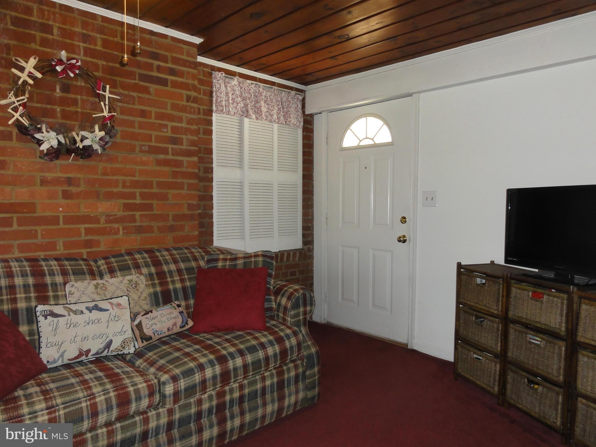5912 Backlick Road Springfield, VA 22150 - Photo 17 of 28 a bedroom with a bed and a flat screen tv