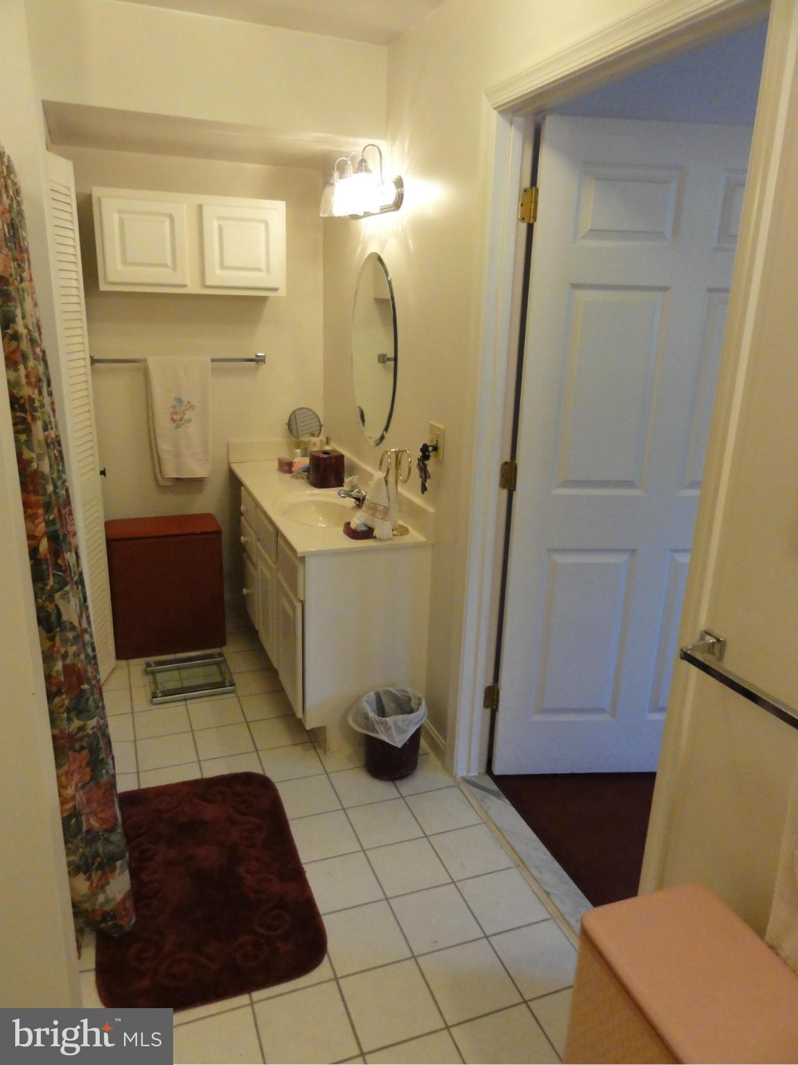 5912 Backlick Road Springfield, VA 22150 - Photo 20 of 28 a bathroom with a sink a toilet and a mirror