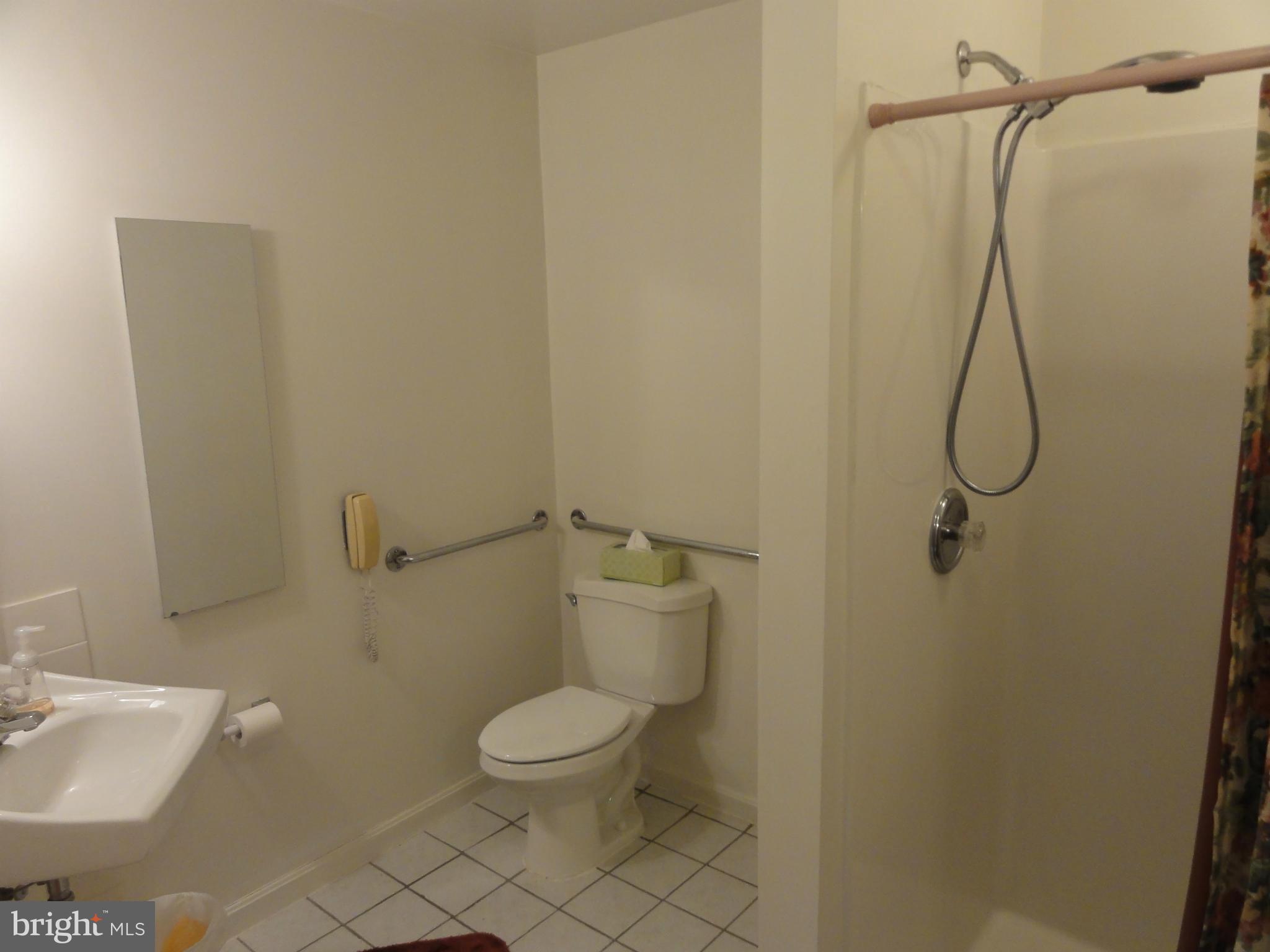 5912 Backlick Road Springfield, VA 22150 - Photo 21 of 28 a bathroom with a toilet sink and shower