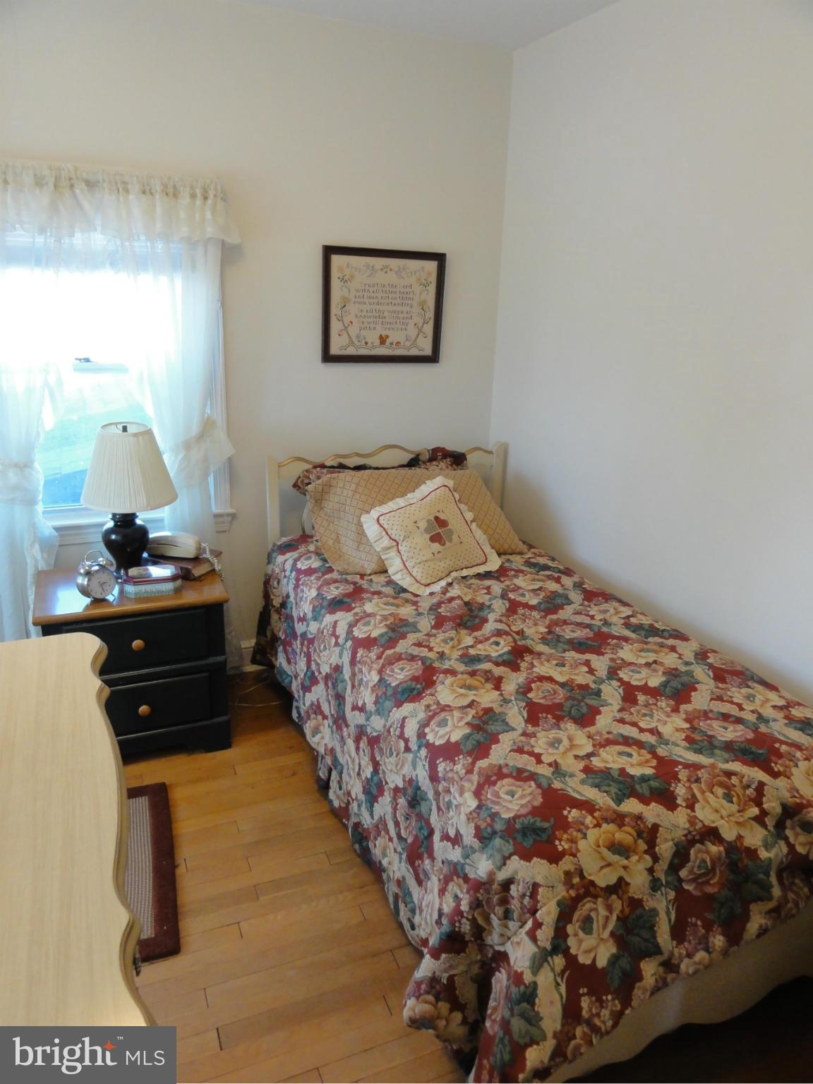 5912 Backlick Road Springfield, VA 22150 - Photo 26 of 28 a bedroom with a bed and a lamp on dresser