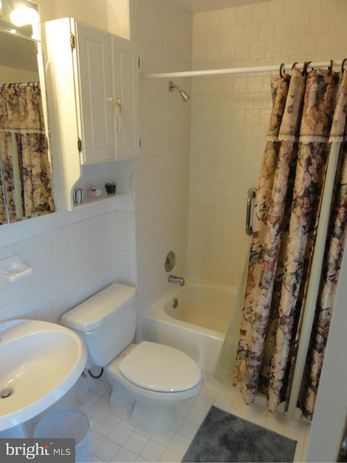 5912 Backlick Road Springfield, VA 22150 - Photo 28 of 28 a white toilet sitting next to a bath tub and shower