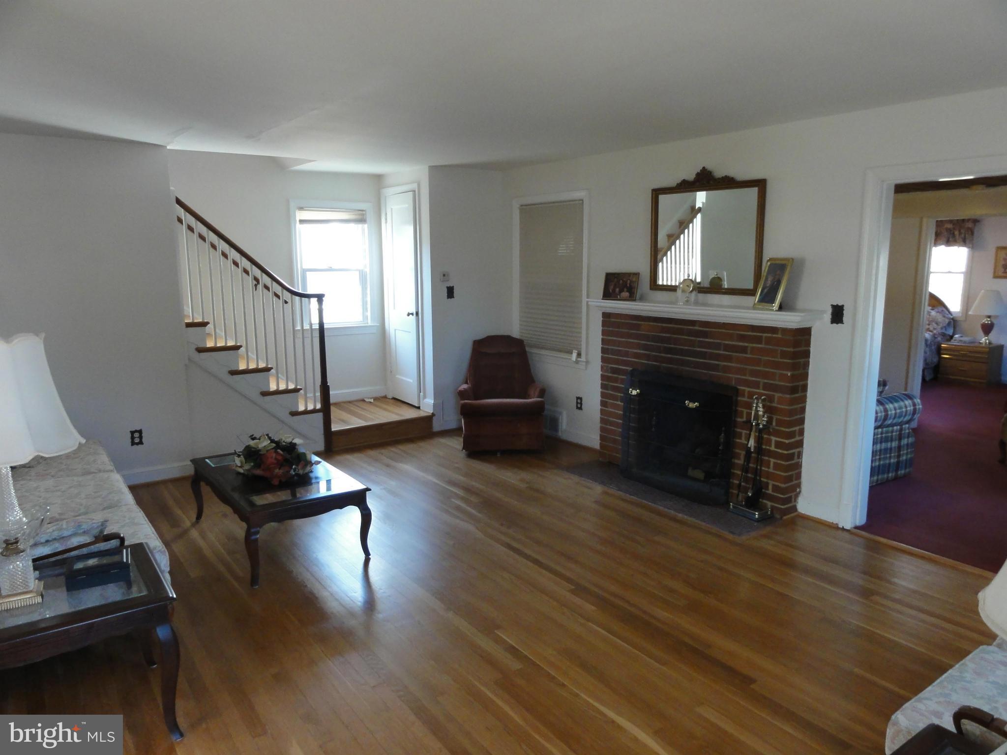 5912 Backlick Road Springfield, VA 22150 - Photo 8 of 28 a living room with furniture and a fireplace
