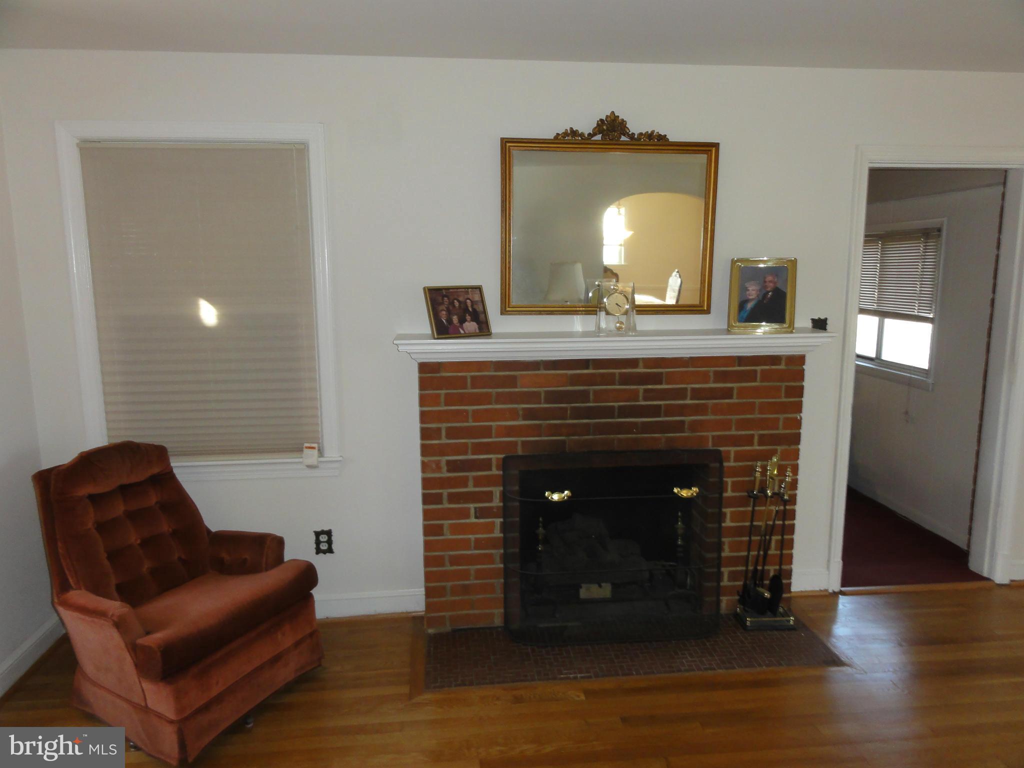 5912 Backlick Road Springfield, VA 22150 - Photo 9 of 28 a living room with furniture and a fireplace