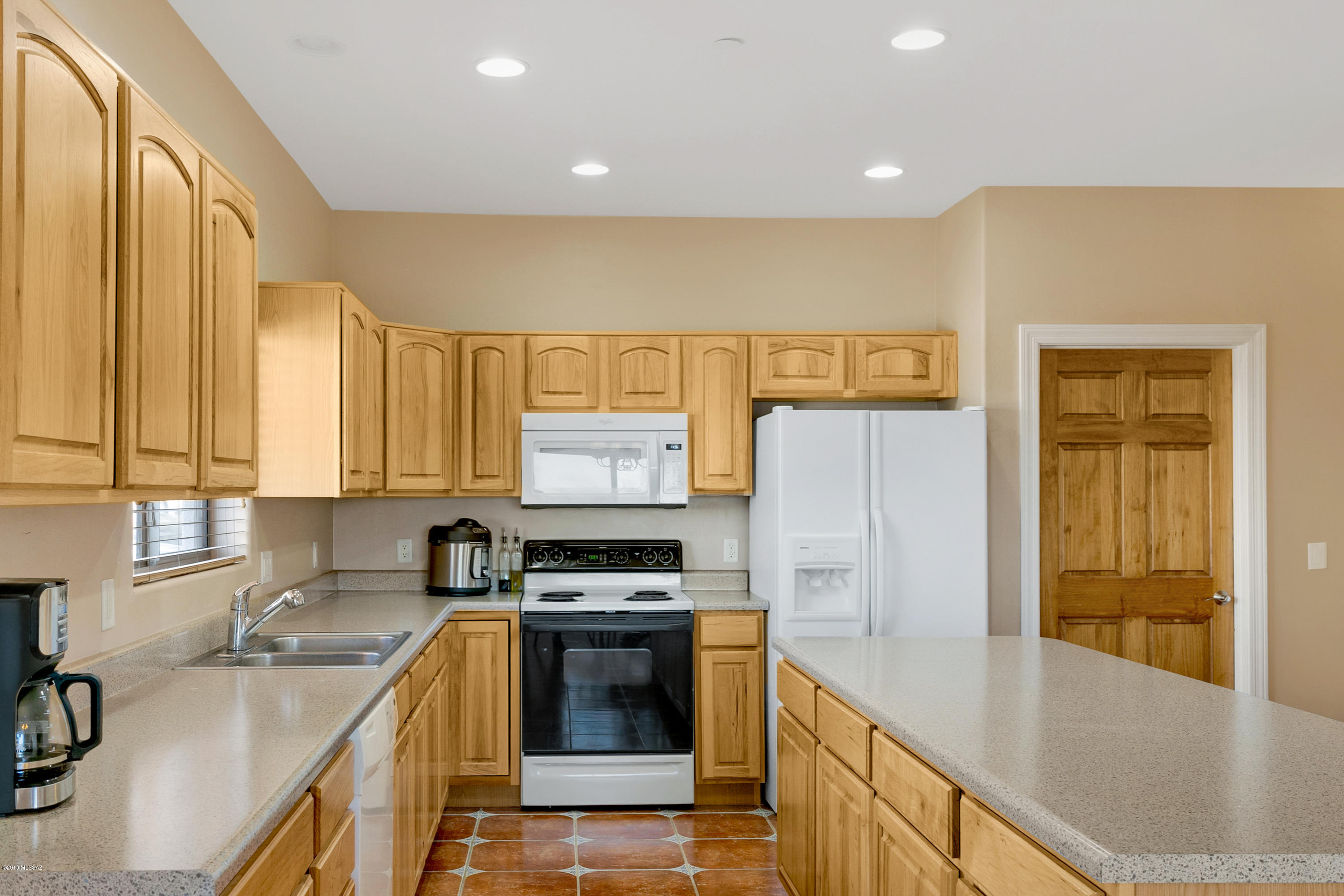 21960 South Helvetia Road Sahuarita, AZ 85629 - Photo 7 of 29 a kitchen with stainless steel appliances a refrigerator sink and stove