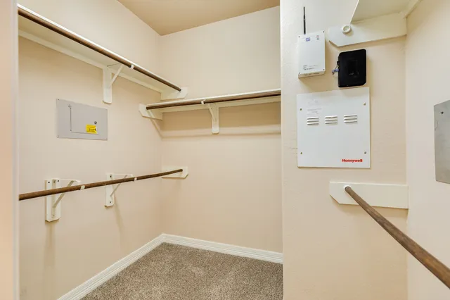 an empty room with a ceiling fan and a window