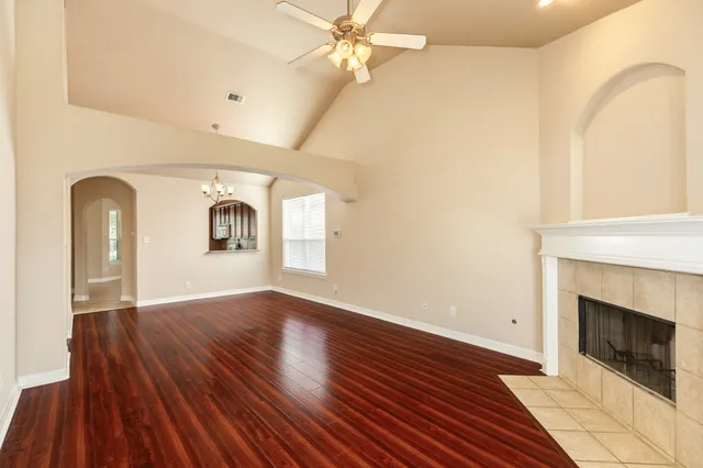 a view of a livingroom with wooden floor and a fireplace