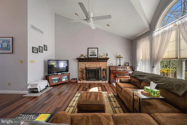 a living room with furniture fireplace and flat screen tv