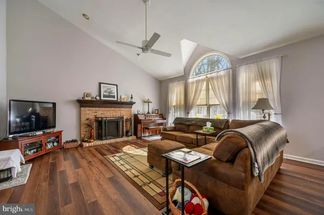 a living room with furniture fireplace and flat screen tv