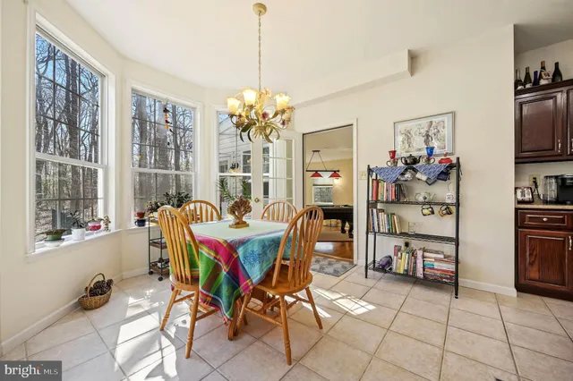 a dining room livingroom with furniture and a chandelier
