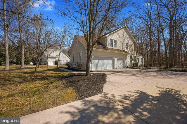 a view of a white house with a yard covered with snow