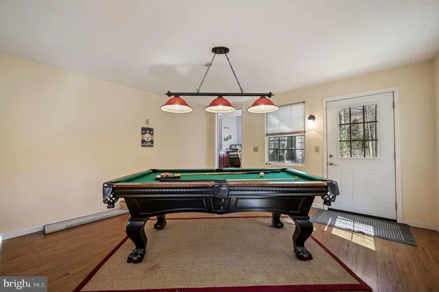a room with a table chairs and wooden floor