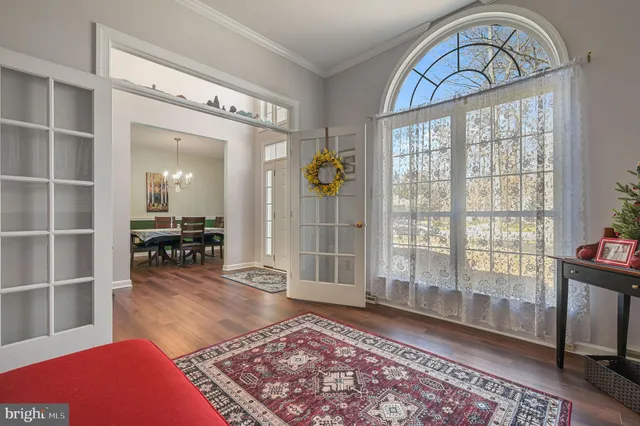 a living room with fireplace furniture and a wooden floor