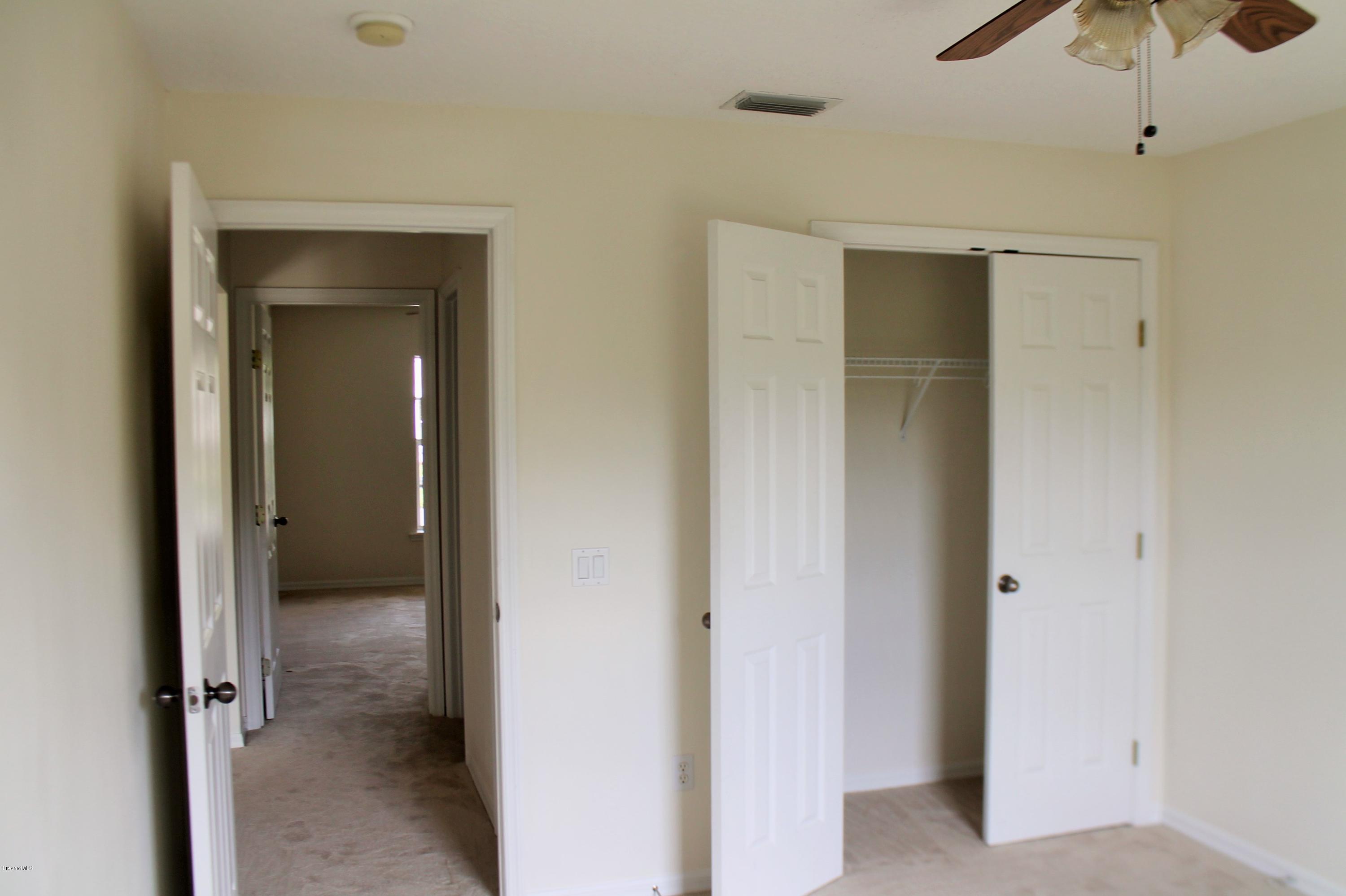 575 Amber Lane Cocoa, FL 32926 - Photo 12 of 16 a view of a room with a wardrobe space