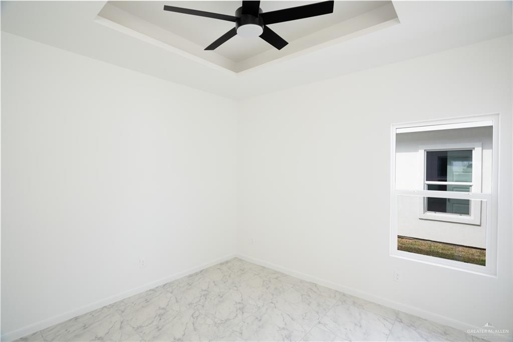 1408 South Xanthia Street, Unit 2 Alton, TX 78573 - Photo 13 of 18 a view of a room with a rack on the wall