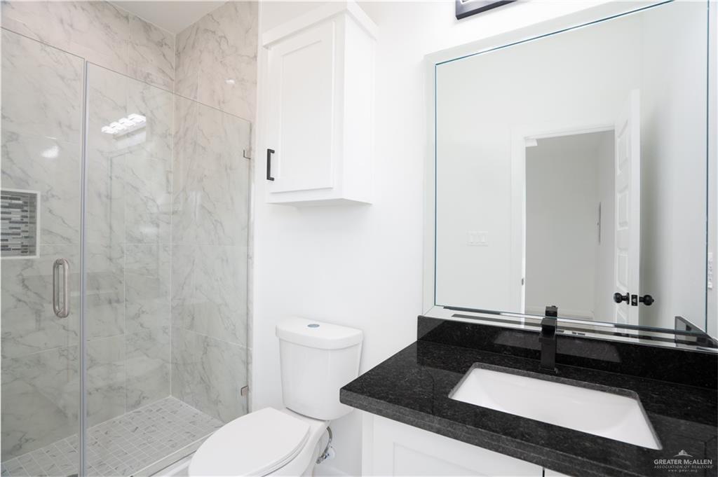 1408 South Xanthia Street, Unit 2 Alton, TX 78573 - Photo 14 of 18 a bathroom with a sink and a toilet