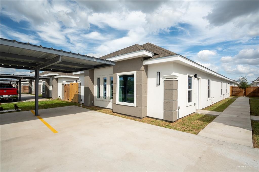 1408 South Xanthia Street, Unit 2 Alton, TX 78573 - Photo 15 of 18 a view of a house with many windows and a small yard
