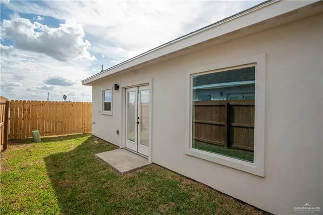 a kitchen with granite countertop a sink stainless steel appliances and cabinets