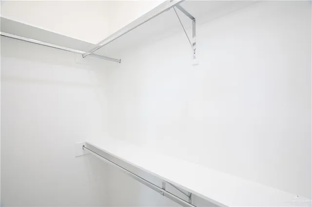 a view of a kitchen with refrigerator and a stove top oven
