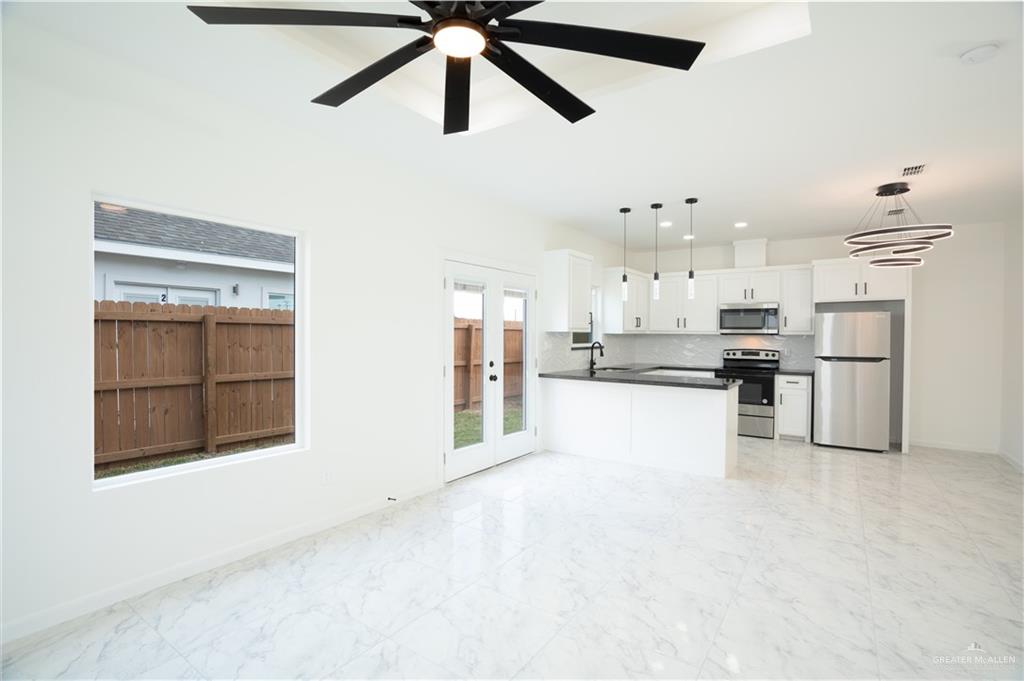 1408 South Xanthia Street, Unit 2 Alton, TX 78573 - Photo 6 of 18 a view of a kitchen with refrigerator and a stove top oven