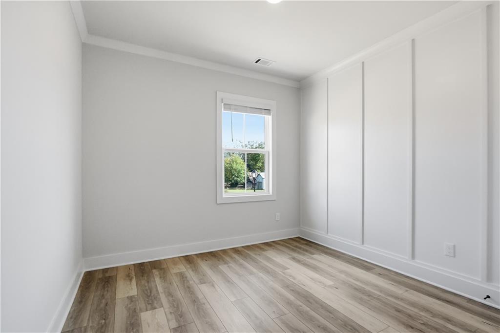 331 Orchid Street Braselton, GA 30517 - Photo 29 of 57 a view of an empty room with wooden floor and a window