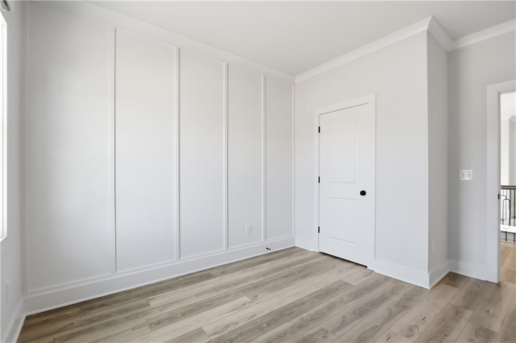 331 Orchid Street Braselton, GA 30517 - Photo 31 of 57 a view of an empty room with wooden floor