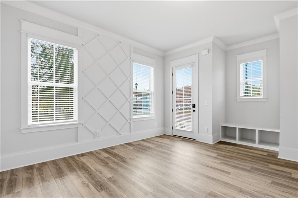 331 Orchid Street Braselton, GA 30517 - Photo 4 of 57 a view of an empty room with wooden floor and windows