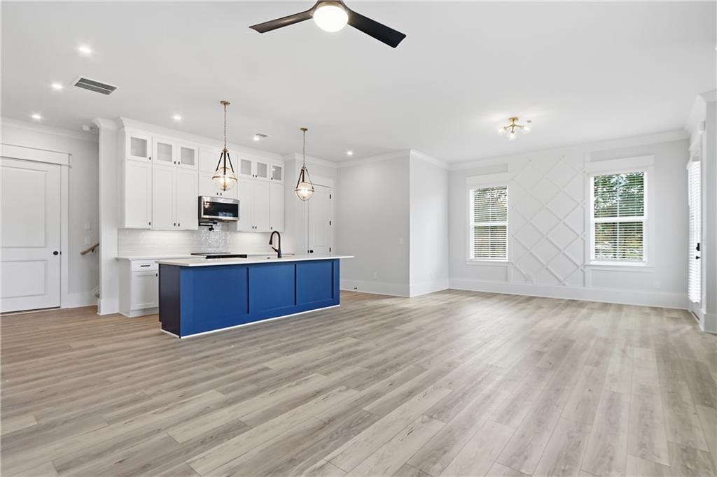 331 Orchid Street Braselton, GA 30517 - Photo 10 of 57 a view of kitchen with kitchen island wooden floors appliances and cabinets