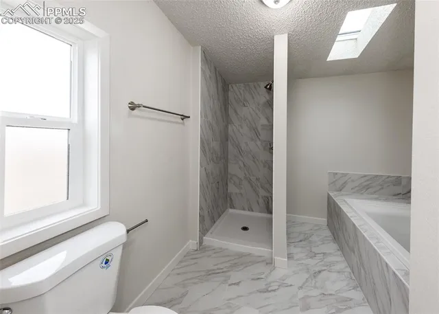 a bathroom with a tub and a shower