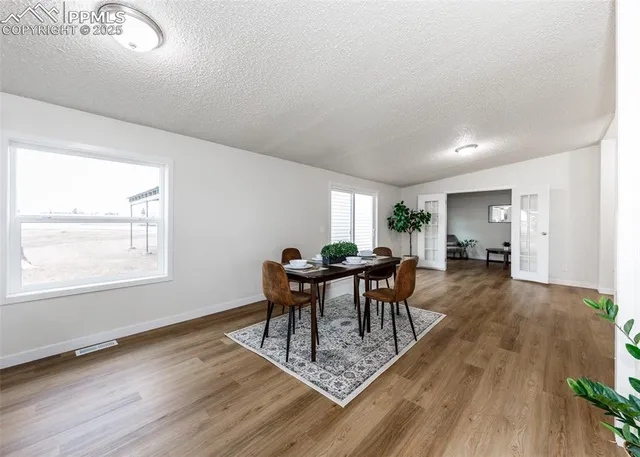 a dining room with furniture a rug and wooden floor