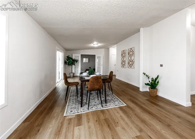 a view of a dining room with furniture window and wooden floor