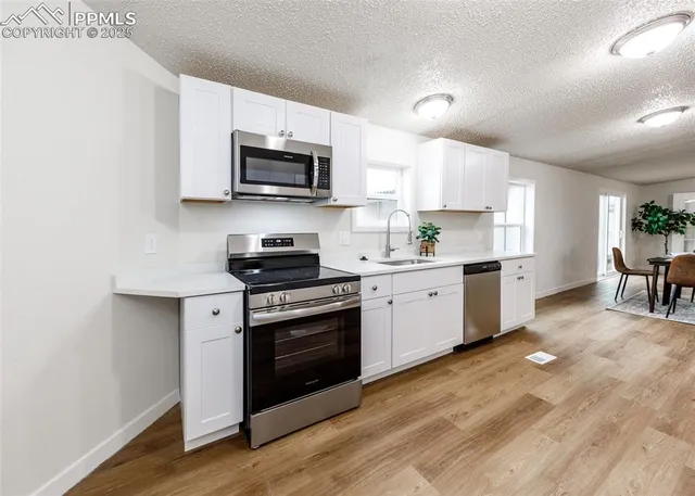 a kitchen that has a sink and a stove