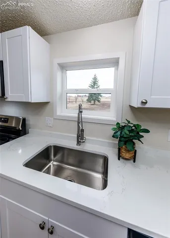 a kitchen with stainless steel appliances a refrigerator and a stove top oven