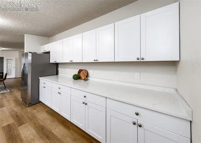 a large kitchen with a lot of counter space and stainless steel appliances