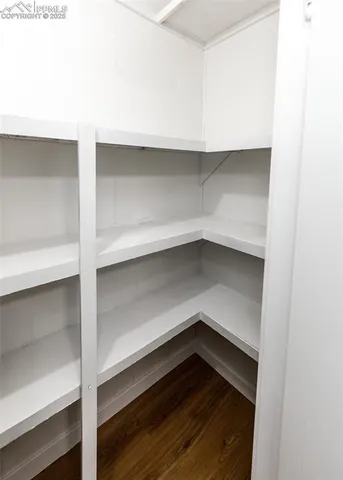 a view of a hallway view with wooden floor and staircase