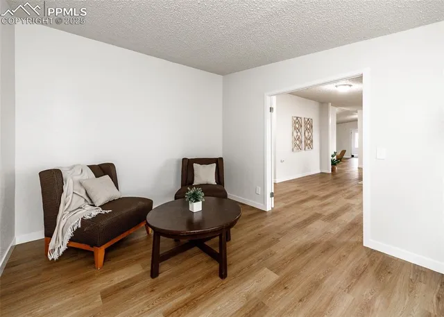 a view of a hallway view with wooden floor and furniture