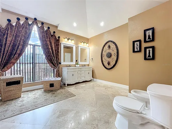 a bathroom with a toilet a sink and a mirror