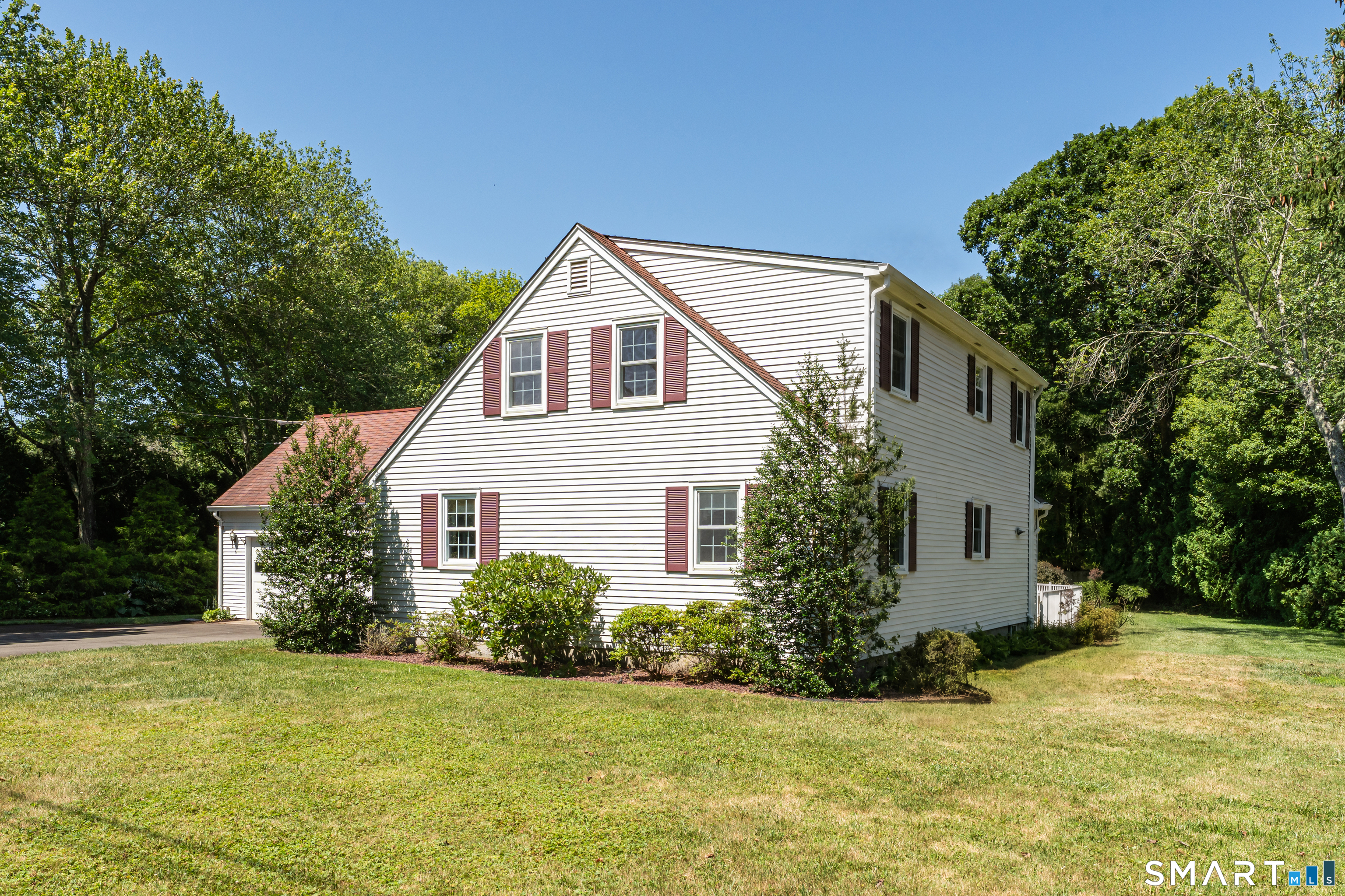 110 Nut Plains Road Guilford, CT 06437 - Photo 34 of 40 Timeless New England lines from every angle, framed by towering trees and a private, park like setting.